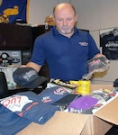 Lee McKinney, a civilian at the 470th Military Intelligence Brigade at Joint base San Antonio-Fort Sam Houston, personally packs and pays for shipping to send care packages with racing memorabilia to deployed service members worldwide.