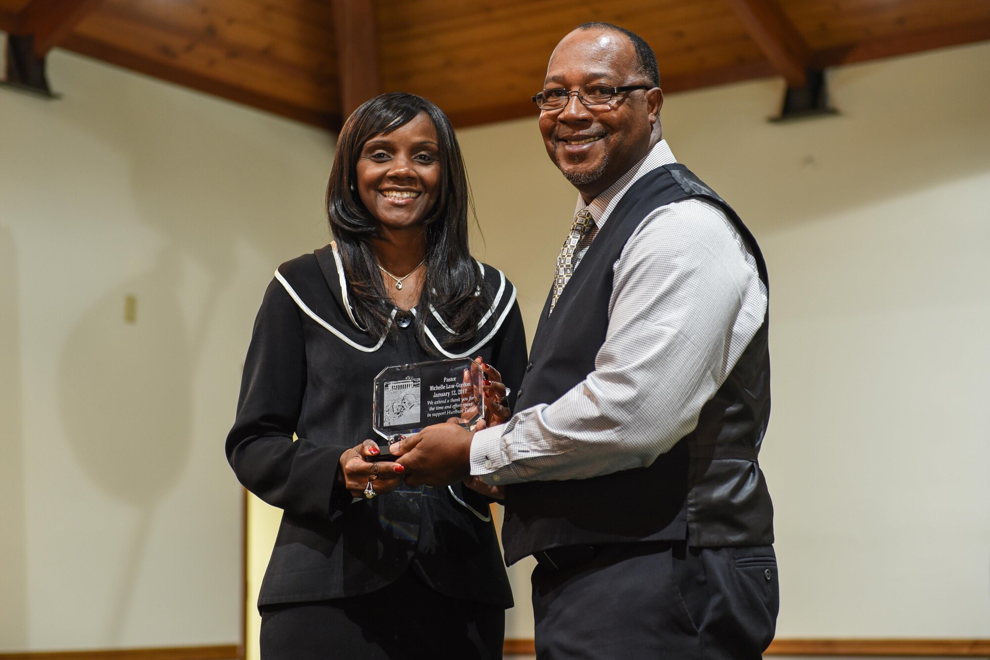 Chaplain (Maj.) Michelle Law-Gordon, staff chaplain with Air Force Reserve Command, is presented a gift from John Armour, chairman of Hurlburt Field’s African-American Heritage Month committee, during the annual Martin Luther King Jr. Commemorative Service at the Hurlburt Field Chapel, Jan. 12, 2017. Law-Gordon was the guest speaker for the event and referred to Martin Luther King Jr. Day as a day on, not a day off. (U.S. Air Force photo by Senior Airman Jeff Parkinson)