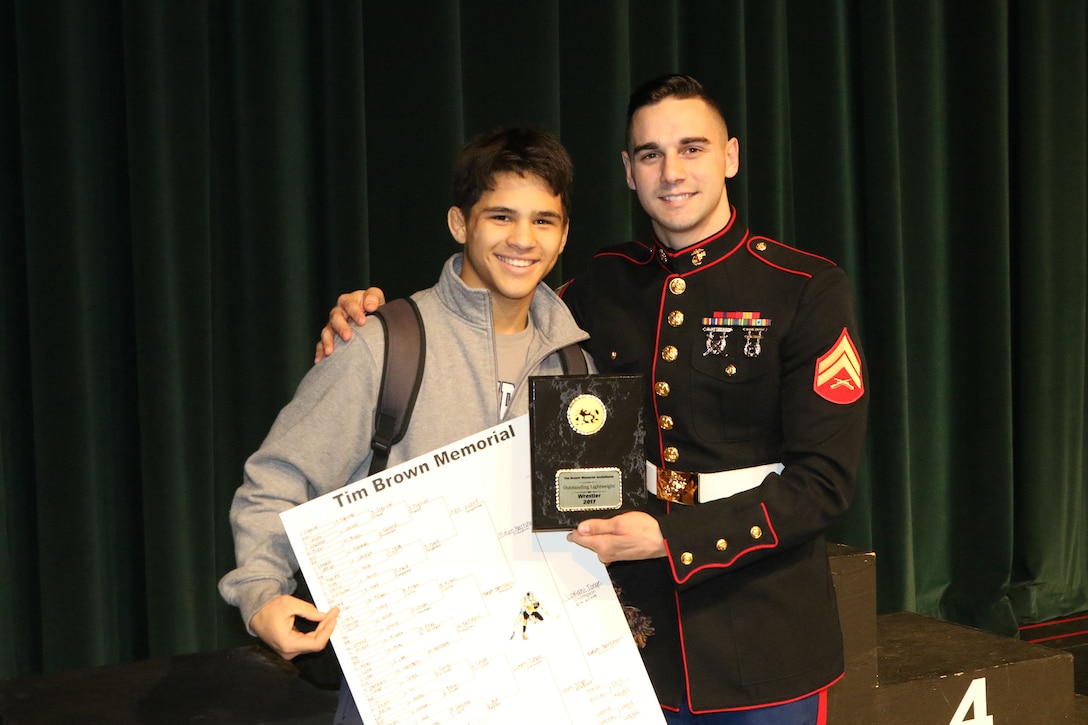Corporal Joshua Russo, All-Marine wrestler, presents the Outstanding Lightweight wrestler award to Lokahi Tonge, Elk Grove High School, for a dominating performance at the Tim Brown Memorial Tournament at Memorial Auditorium in Sacramento, Jan. 14, 2017. The tournament is dedicated to Lance Cpl. Timothy W. Brown, a Sacramento native and former Foothill High School wresters who was killed in action in Al Anbar province, Iraq, on Nov. 15, 2006, while serving as an infantryman with 2nd Battalion, 3rd Marine Regiment. Each year, his alma matter hosts a wrestling tournament featuring hundreds of top-tier athletes from throughout California.
(U.S. Marine Corps photo by Staff Sgt. Jacob H. Harrer)