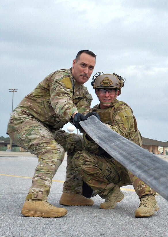 Master Sgt. James Albanesi, the team chief for the forward area refueling point program with the 1st Special Operations Logistics Readiness Squadron, assists a student as they anchor a fuel hose during a class demonstration at Hurlburt Field, Fla., Jan. 10, 2017. A fuel hose is anchored by Airmen to ensure little movement while a squeegee, a metal tool with two rolling pin like devices, is used to push residual fuel back into an aircraft to save space and reduce risk of leaks or spillage. The FARP program is a United States Special Operations Command initiative that trains petroleum, oils and lubrication Airmen to perform covert, nighttime refueling operations in deployed locations where fueling points are not accessible or when air-to-air refueling is not possible. (U.S. Air Force photo by Senior Airman Andrea Posey)