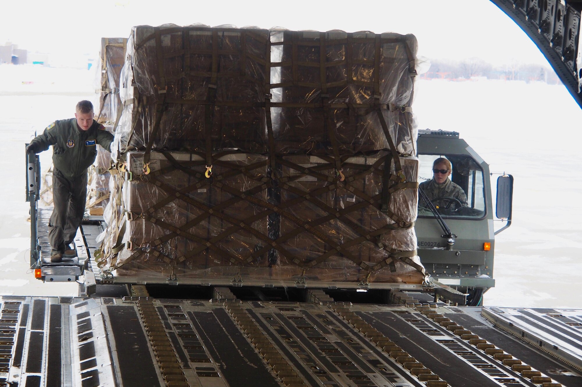 With temperatures near zero, more than 50,000 pounds of humanitarian cargo is uploaded Jan. 13 at the 934th Airlift Wing by members of the 27th Aerial Port Squadron.  The cargo was headed for Northern Iraq as part of the Denton program.