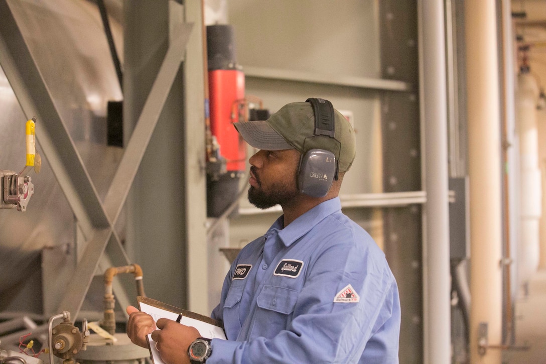 Mike Spillard, boiler plant operator, Public Works Division, checks the turbine of a cogeneration plant aboard Marine Corps Air Ground Combat Center, Twentynine Palms, Calif., Jan. 12, 2016. Spillard was one of the five men who helped return power to the Combat Center on New Year’s Day. (Official Marine Corps photo by Cpl. Thomas Mudd/Released)