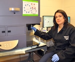 Dr. R. Madelaine Paredes, a researcher in Naval Medical Research Unit San Antonio’s Immunodiagnostic and Bioassay Development Department, demonstrates the use of the flow cytometer technique to perform single cell measurements. Flow cytometer can identify the numbers of cells that have a particular feature (size, or a specific marker in their surface or intracellular). Navy researchers can then discern what molecules are being produced by each cell type and compile an extensive inflammatory profile for that particular sample. 