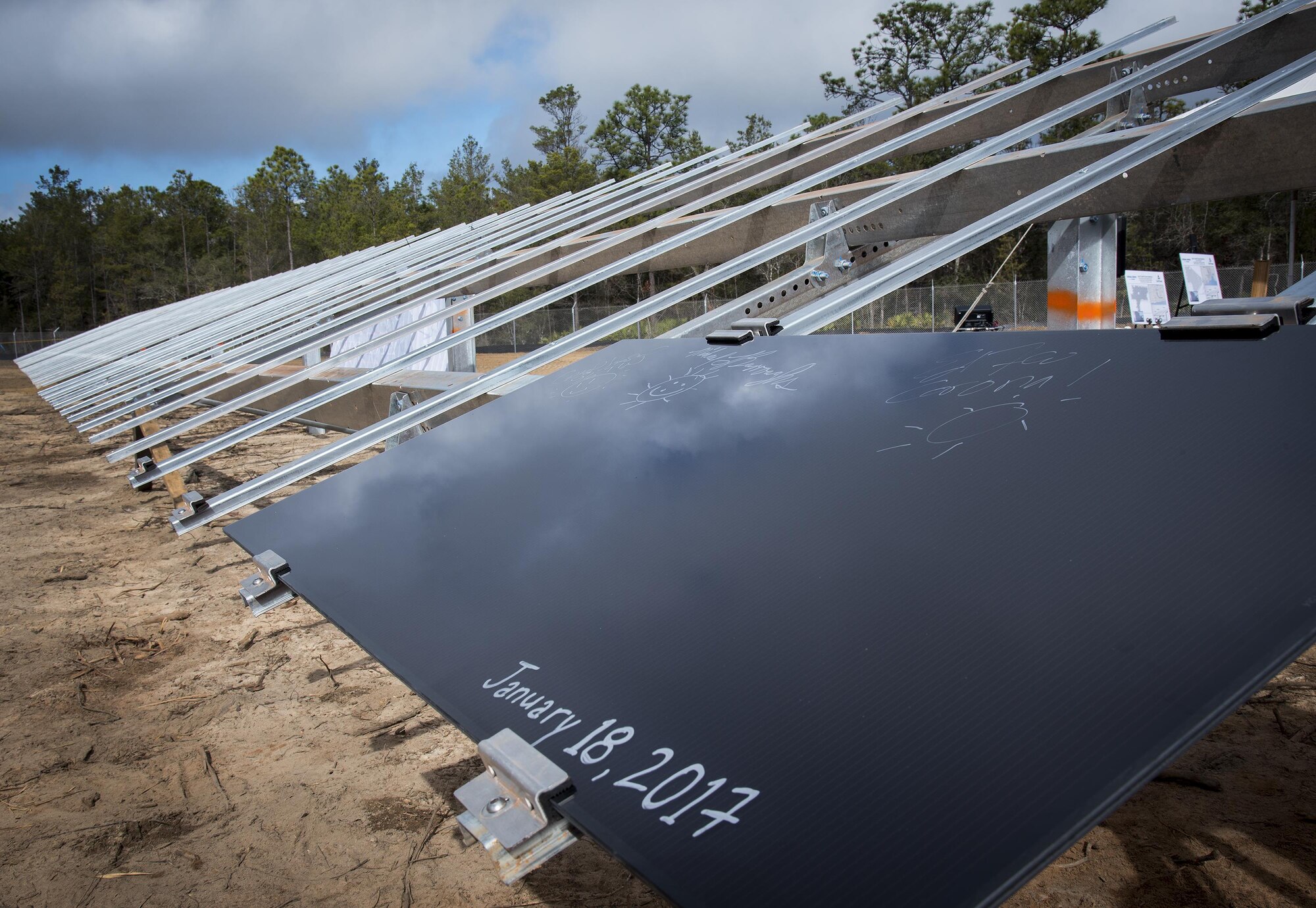 The first of the eventual 375,000 solar panels sits on it rack after a ceremonial initial installation ceremony Jan. 18 at Eglin Air Force Base, Fla.  Leaders from the three project partners, Air Force, Gulf Power and Coronal Development Services, were on hand to install the first panel located on the 240-acre site.  (U.S. Air Force photo/Samuel King Jr.)