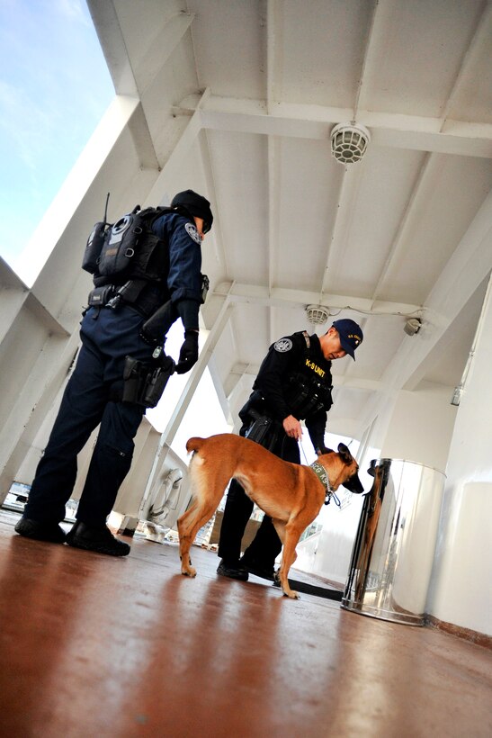 Coast Guard Petty Officer 2nd Class Richard Bacone, Chief Petty Officer Carlos Perez and Ruthie, a military working dog, conduct security sweeps during a dinner cruise in Washington, D.C., Jan. 19, 2017. Bacone, Peraz and Ruthie are assigned to Maritime Safety and Security Team New York. Coast Guard photo by Petty Officer 2nd Class Matthew S. Masaschi