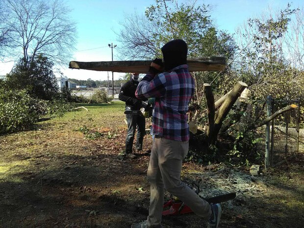 Marines assist their off-base neighbor with cutting up trees and removing debris after severe storms that swept through the city of Albany, Ga., and surrounding counties, Jan. 2.   