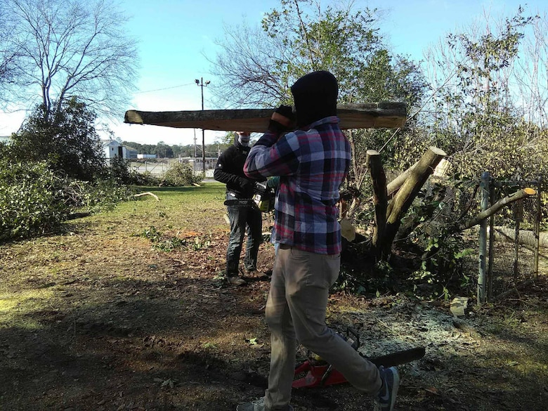 Marines assist their off-base neighbor with cutting up trees and removing debris after severe storms that swept through the city of Albany, Ga., and surrounding counties, Jan. 2.   