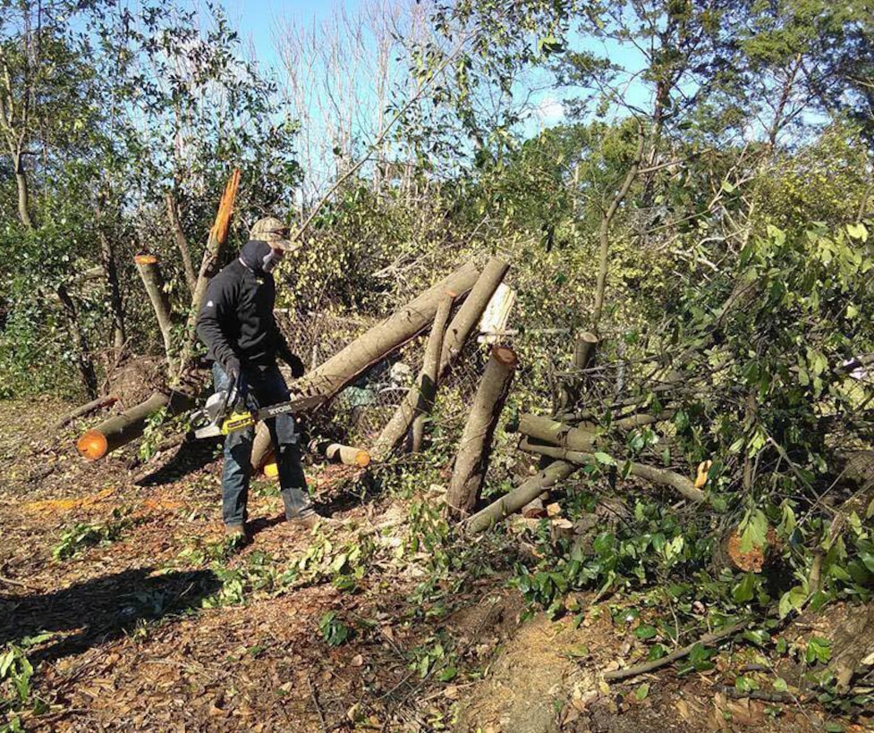 Cpl. Kane Keaton, admin clerk, Military Personnel, Marine Corps Logistics Base Albany, uses his chainsaw to cut trees after severe storms swept through the city of Albany, Ga., and surrounding counties, Jan. 7.  

 