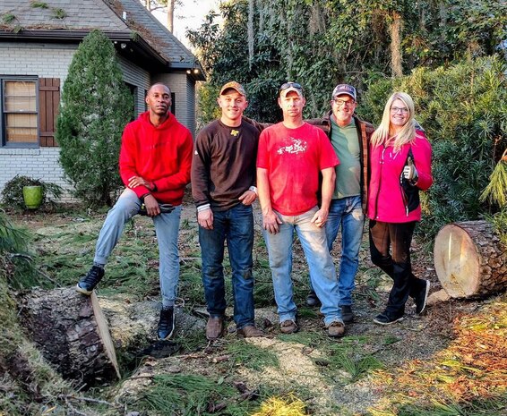 Marines pose for a photo with Jerry Usry, a community volunteer, after cutting down a pine tree that had fallen during a recent severe storm, Jan. 7
 