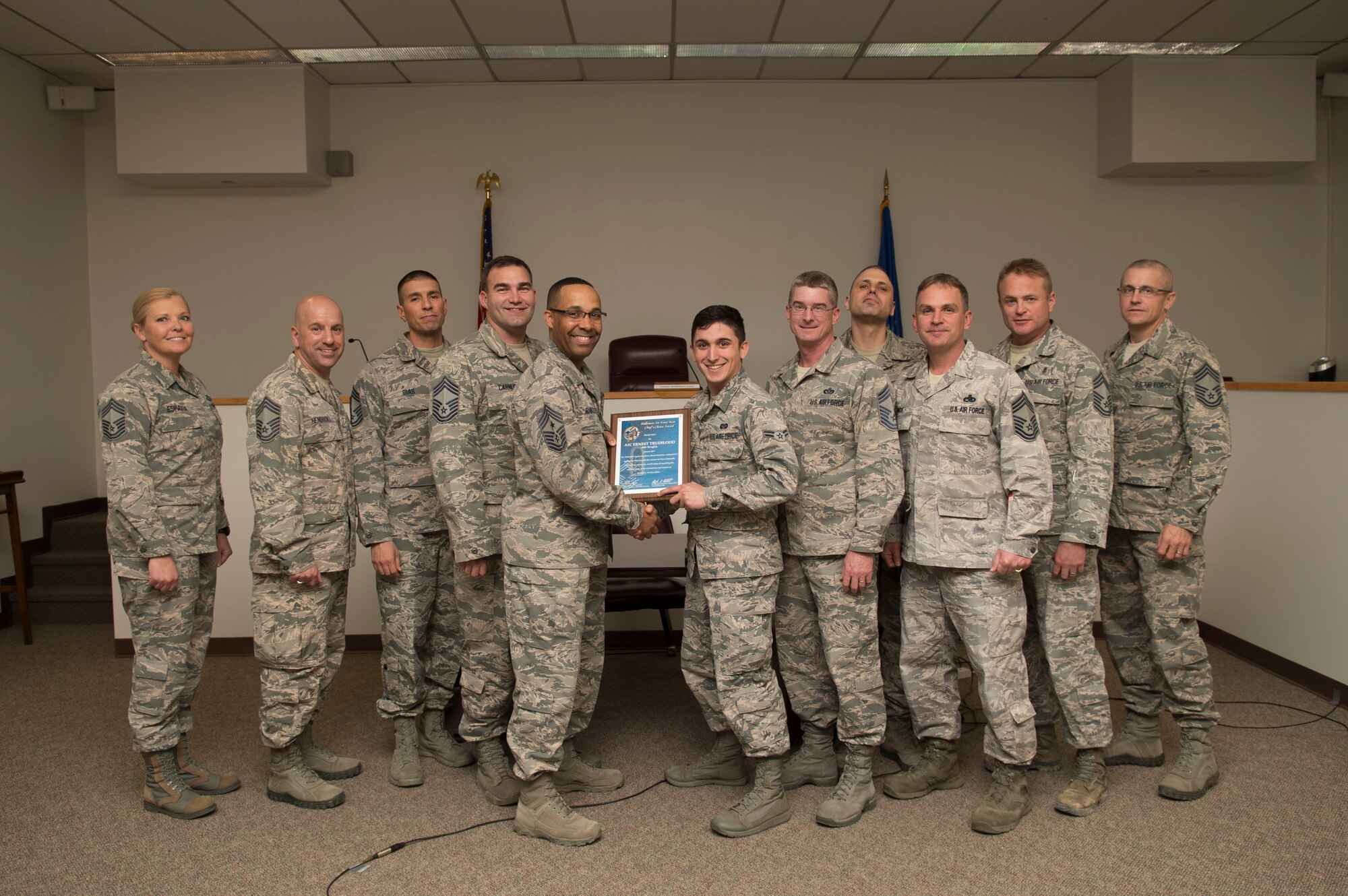 Airman 1st Class Ernest Trueblood, a 49th Wing Judge Advocate paralegal, receives the January Chief’s Choice Award, from Chief Master Sgt. Barrington Bartlett, the 49th Wing command chief Jan. 19, 2017, at Holloman Air Force Base, N.M. (U.S. Air Force photo by Tech. Sgt. Amanda Junk)