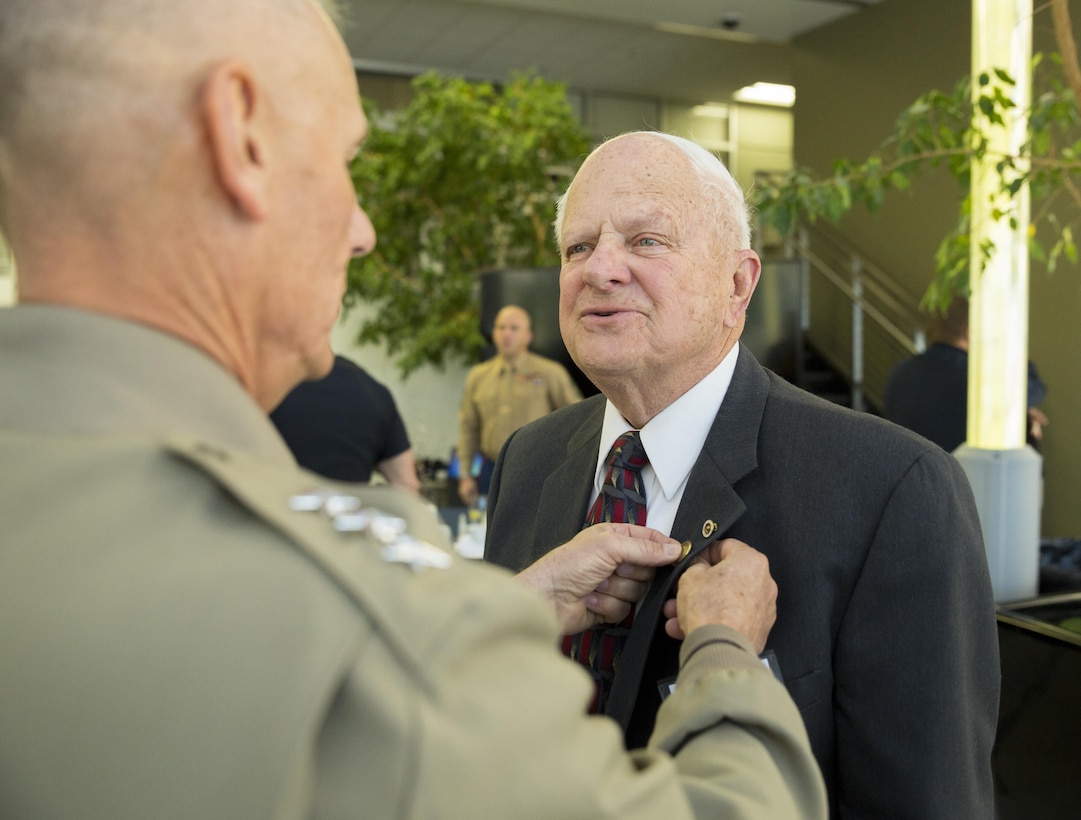 Lt. Gen. Rex C. McMillian (left), commander of Marine Forces Reserve and Marine Forces North, pins a Vietnam pin onto retired Col. David Leighton to recognize him for his services as a pilot during the Vietnam War at the Lockheed Martin Event Center in Littleton, Colo., Jan. 17, 2017. McMillian attends the executive breakfast to commemorate the 100th anniversary of the Marine Corps Reserve. From World War I through the wars in Iraq and Afghanistan, Reserve Marines have played an essential role in the Marine Corps Total Force by augmenting and reinforcing the active component across the full range of military operations. (U.S. Marine Corps photo by Lance Cpl. Dallas Johnson/Released)