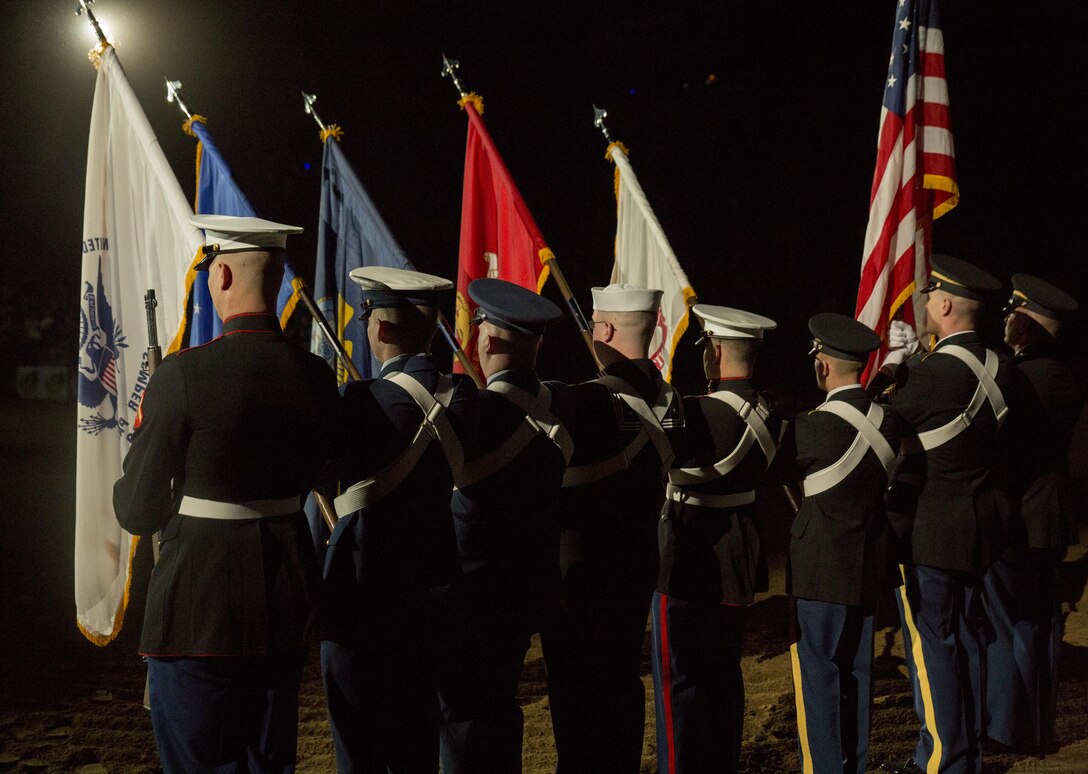 Service members from Buckley Air Force Base participated in a joint color guard with Marine Corps Band New Orleans at the National Western Stock Show in Denver, Jan. 17, 2017. The NWSS honored veterans to show their dedication to the military and to bring attention to the 100th anniversary of the Marine Corps Reserve. (U.S. Marine Corps photo by Lance Cpl. Dallas Johnson/Released)