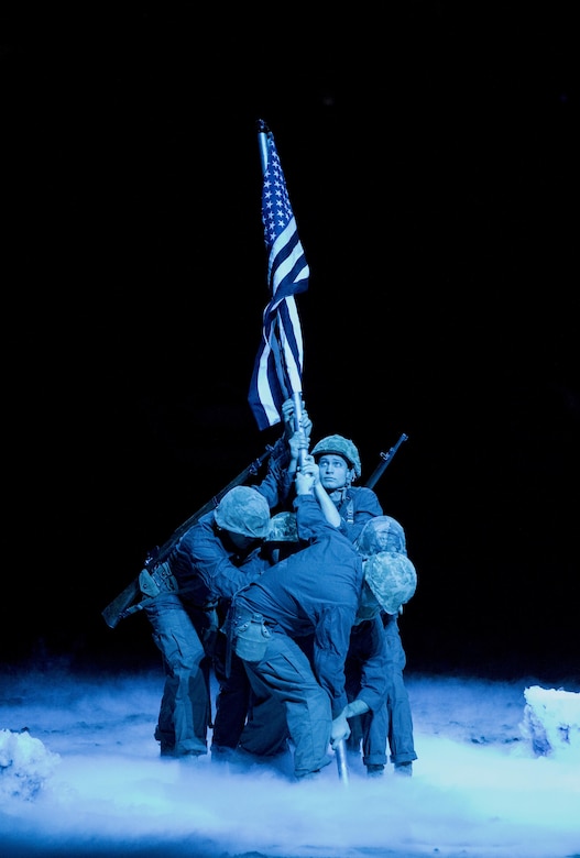 Reserve Marines from Production and Analysis Company, Intelligence Support Battalion, Force Headquarters Group, participated in the closing ceremony of the National Western Stock Show in Denver, Jan. 17, 2017. The Marines re-enacted the flag rising on Mount Suribachi to pay homage to World War II veterans who fought at the Battle of Iwo Jima. The NWSS honored veterans to show their dedication to the military and to bring attention to the 100th anniversary of the Marine Corps Reserve. (U.S. Marine Corps photo by Lance Cpl. Dallas Johnson/Released)