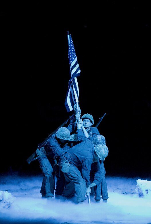 Reserve Marines from Production and Analysis Company, Intelligence Support Battalion, Force Headquarters Group, participated in the closing ceremony of the National Western Stock Show in Denver, Jan. 17, 2017. The Marines re-enacted the flag rising on Mount Suribachi to pay homage to World War II veterans who fought at the Battle of Iwo Jima. The NWSS honored veterans to show their dedication to the military and to bring attention to the 100th anniversary of the Marine Corps Reserve. (U.S. Marine Corps photo by Lance Cpl. Dallas Johnson/Released)