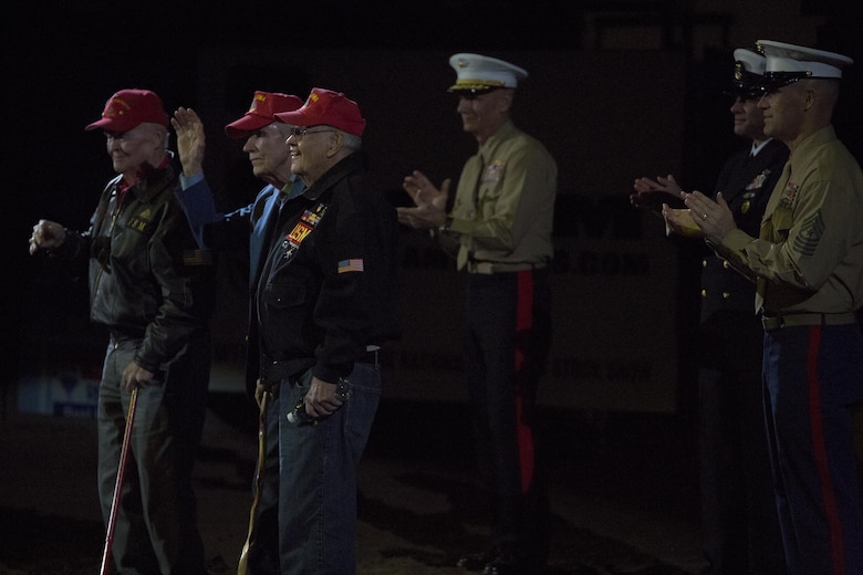 World War II veterans accept a standing ovation during the closing ceremony of the National Western Stock Show in Denver, Jan. 17, 2017, as leaders of Marine Forces Reserve show their support in appreciation for the sacrifices the men made for their country. The NWSS honored veterans to show their dedication to the military and to bring attention to the 100th anniversary of the Marine Corps Reserves. (U.S. Marine Corps photo by Lance Cpl. Dallas Johnson/Released)