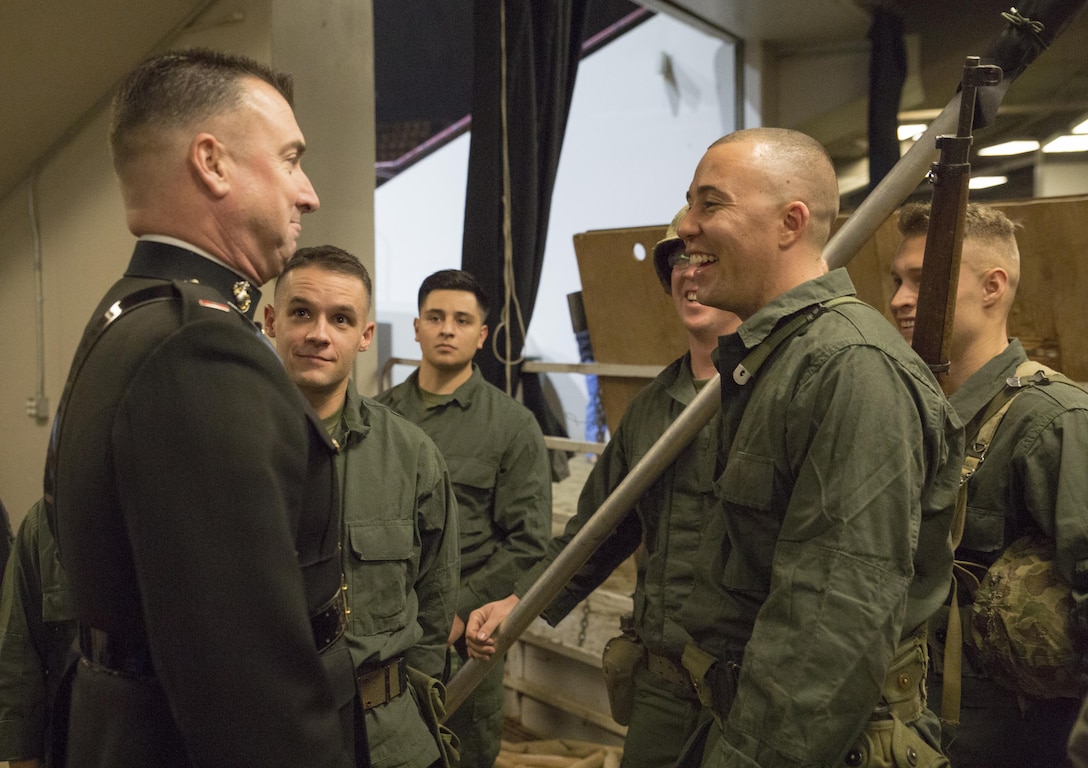 Chief Warrant Officer 3 Michael J Smith (left), band officer of Marine Corps Band New Orleans, speaks with Reserve Marines from Production and Analysis Company, Intelligence Support Battalion, Force Headquarters Group, at the National Western Stock Show in Denver, Jan. 17, 2017. The Marines re-enacted the flag raising on Mount Suribachi to commemorate World War II veterans who fought at the Battle of Iwo Jima. The event was hosted in order to commemorate veterans and the 100th anniversary of the Marine Corps Reserve. (U.S. Marine Corps photo by Lance Cpl. Dallas Johnson/Released)