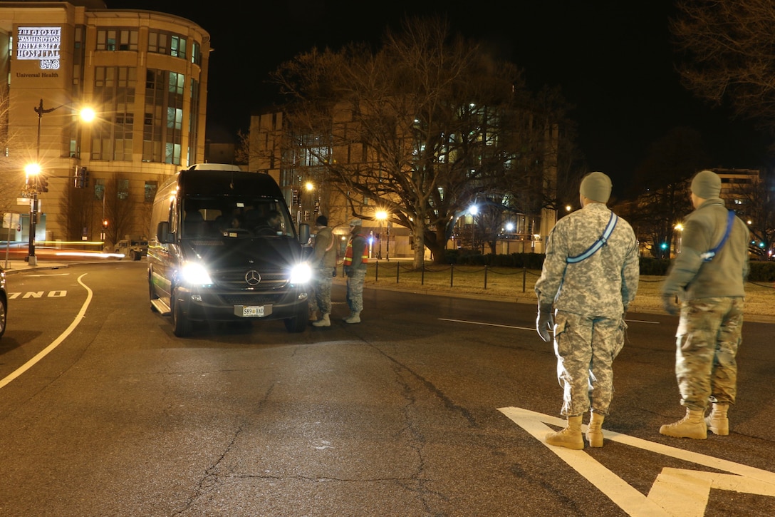 Soldiers provide security at an intersection during the early morning hours before the 58th presidential inauguration in Washington, D.C., Jan. 20, 2017. The soldiers are assigned to the Delaware Army National Guard. Army National Guard photo by 2nd Lt. Brendan Mackie 