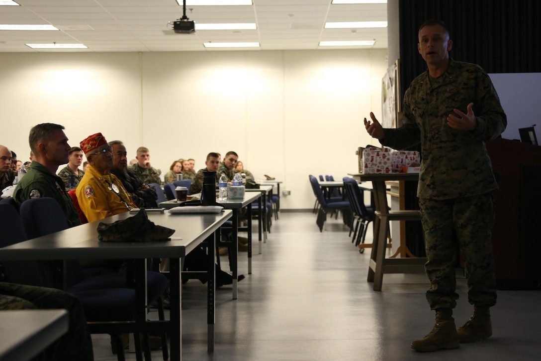 Brig. Gen. Matthew Glavy speaks to Marines aboard Marine Corps Air Station Cherry Point, N.C., Jan. 17, 2017. Both Glavy and Navajo Code Talker Thomas Begay spoke to Marines assigned to Marine Unmanned Aerial Vehicle Squadron 2, Marine Aircraft Group 14, 2nd Marine Aircraft Wing, in regards to the past, present and future of the Marine Corps. Glavy is the 2nd MAW commanding general. (U.S. Marine Corps photo by Cpl. Jason Jimenez/ Released)