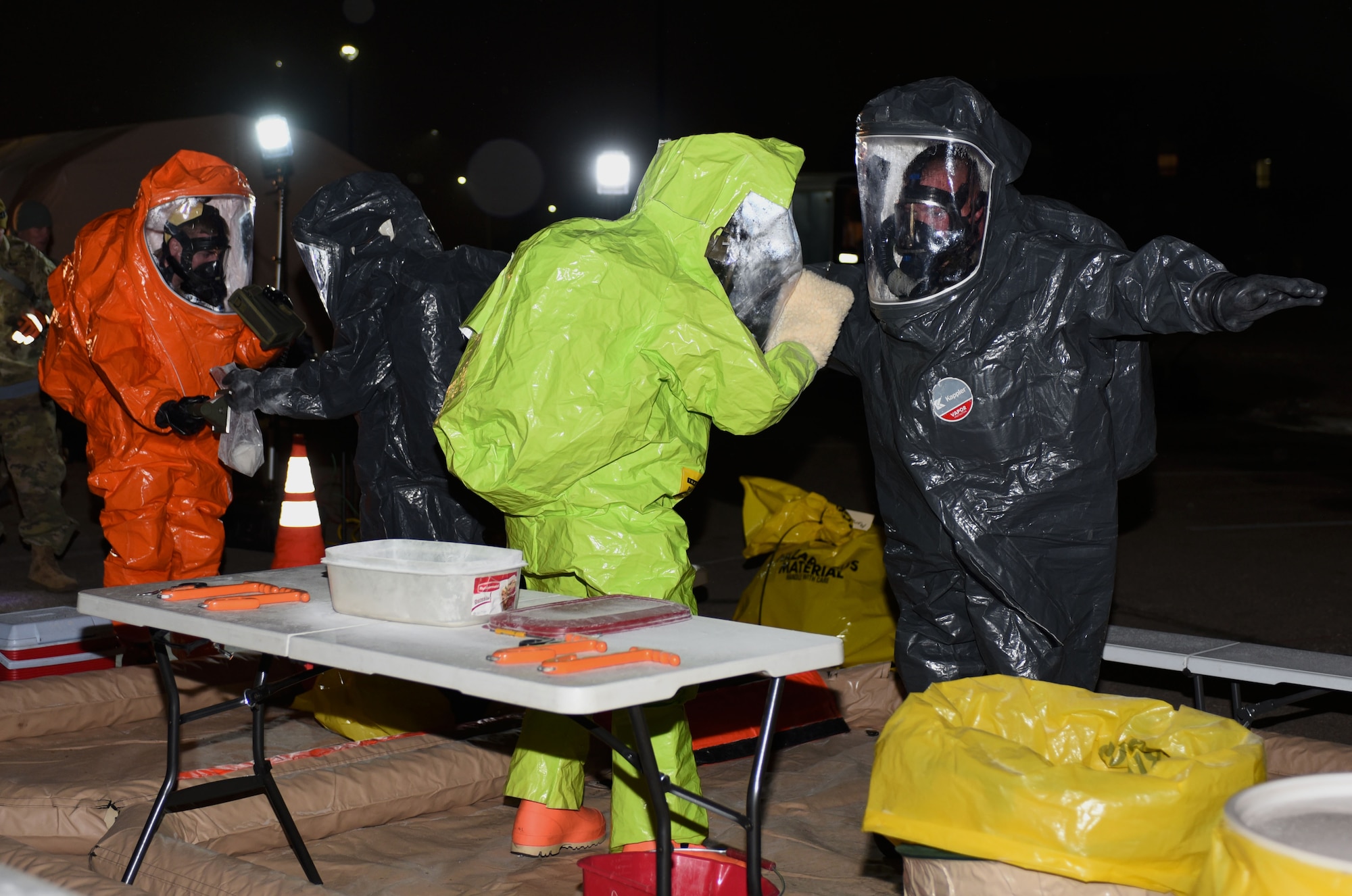 Airmen from the 28th Civil Engineer Squadron and members of the South Dakota National Guard participate in a joint training exercise at Ellsworth Air Force Base, S.D., Jan. 10, 2017. After responding to a simulated training, participants went through a decontamination line to properly dispose of possibly contaminated gear. (U.S. Air Force photo by Airman 1st Class Denise M. Jenson)