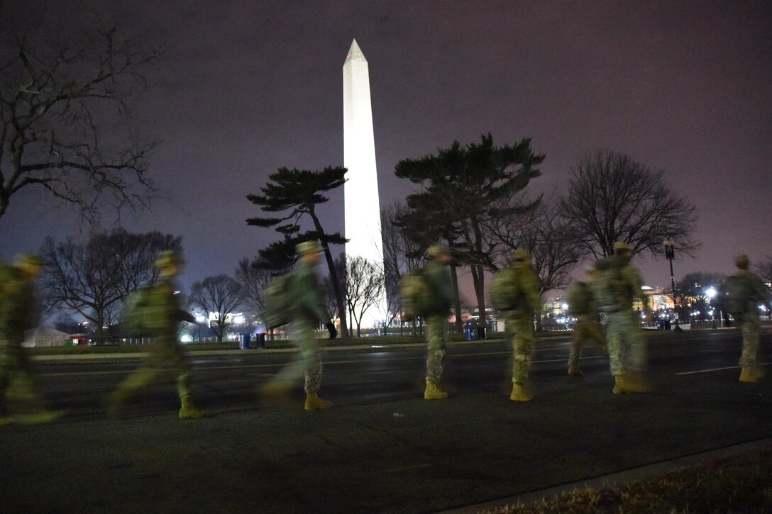 National Guardsmen walk past the Washington Monument on their way to support the 58th presidential inauguration in Washington, D.C., Jan. 20, 2017. The soldiers are assigned to the South Carolina National Guard. Army National Guard photo by Capt. Jessica Donnelly