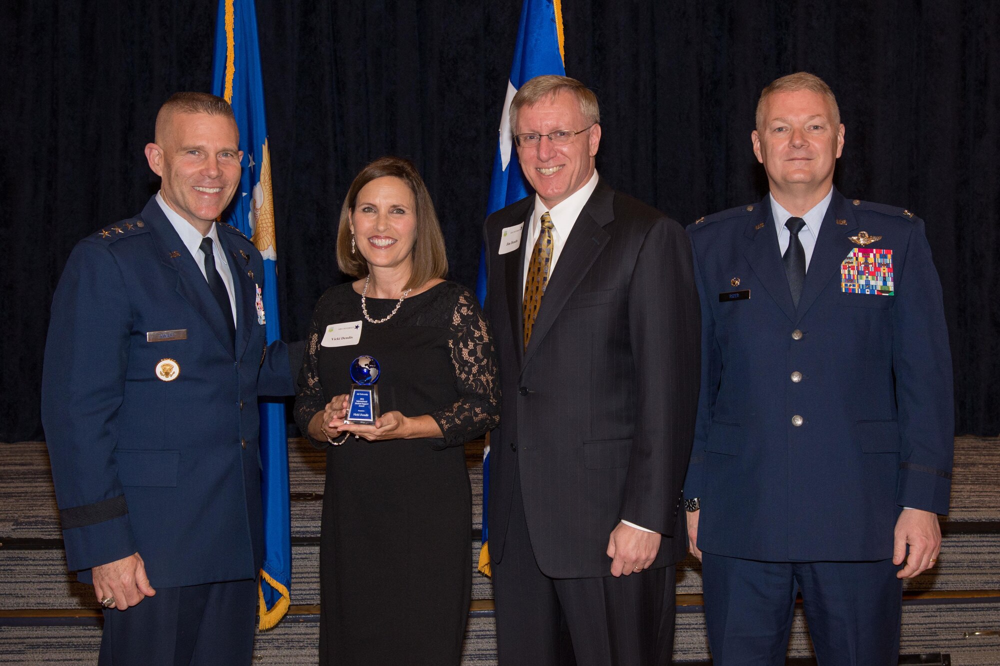 Lt. Gen. Steven Kwast, Air University commander and president, awards Vicki Dendis as the International Student International Student Support winner during the Alabama Goodwill Ambassadors Appreciation Night event, Jan. 17, 2017, Maxwell Air Force Base, Ala. Dendis' support to the International Officer School included her cultivation of a network between international families and the community through various activities and events. (US Air Force photo by Trey Ward)
