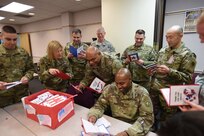 Army Reserve Soldiers assigned to the 85th Support Command read through a box of 'Thank You' letters sent from a local elementary school, Jan. 8, 2017. More than 170 letters were sent with personal 'Thank Yous' and drawings of the student's family members, Soldiers, and first responders. 
(Photo by Sgt. Aaron Berogan)