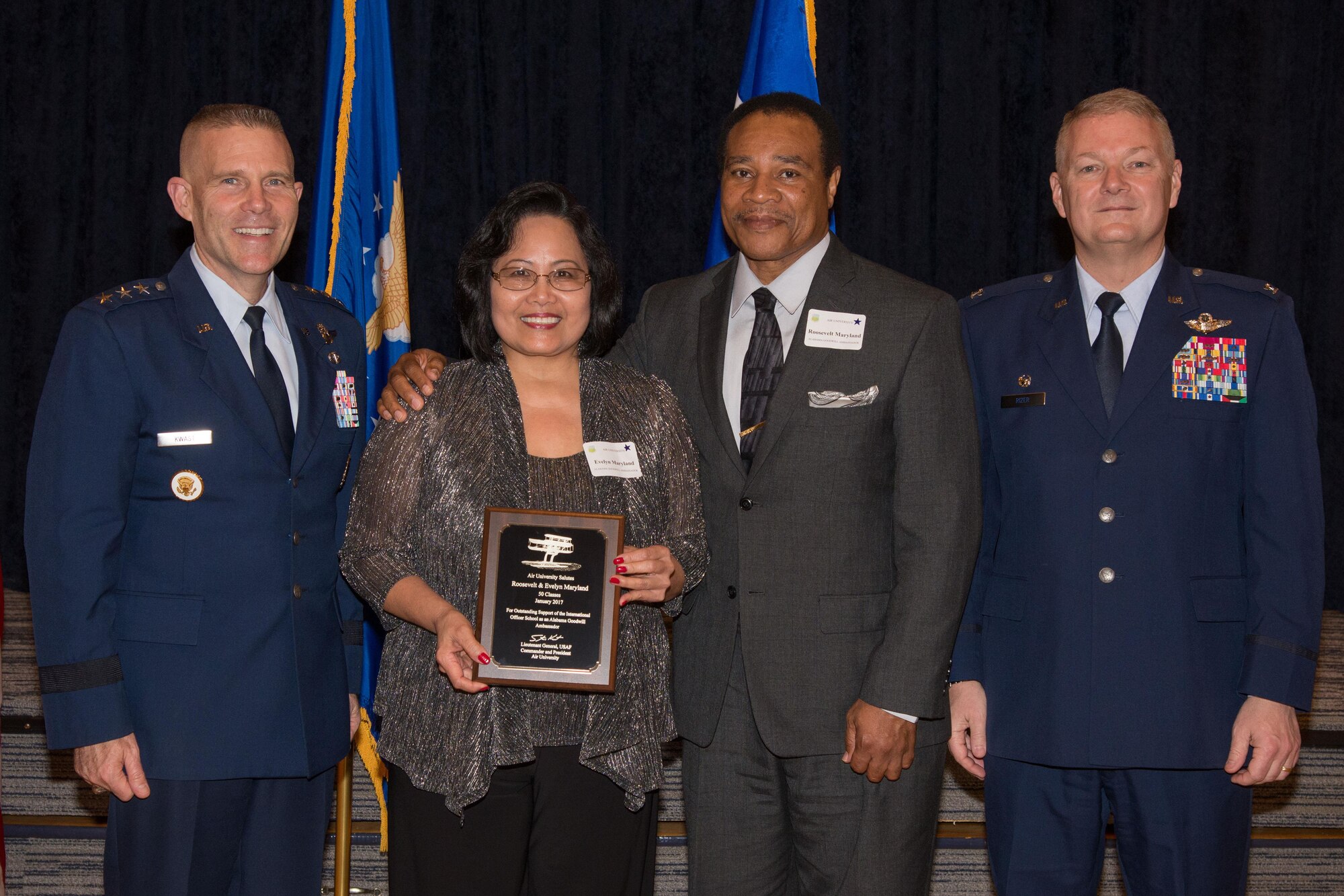 Alabama Goodwill Ambassadors, Roosevelt and Evelyn Maryland receive a plague and thanks from Lt. Gen. Steven Kwast, Air University commander and president, during the Alabama Goodwill Ambassadors Appreciation Night event, Jan. 17, 2017, Maxwell Air Force Base, Ala. Roosevelt and Evelyn has sponsored 50 International Officer School classes, the most out of all the other recipients that night.  (US Air Force photo by Trey Ward)