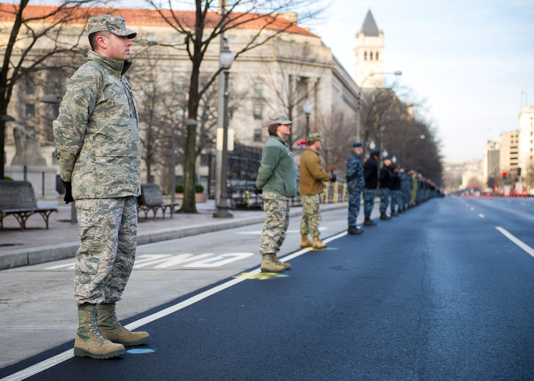 Airmen and Sailors stand along Pennsylvania Avenue during the 58th Presidential Inauguration cordon and parade practice held in Washington, D.C., Jan. 15, 2017. The Parade route spans 1 1/2 miles, from the U.S. Capitol to the White House. (U.S. Air Force photo by Airman Gabrielle Spalding)