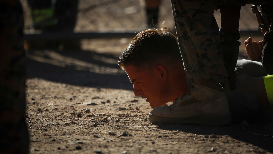 Marines with 2nd Battalion, 3rd Marine Regiment, based out of Marine Corps Base Hawaii, subdue a role player at Kiwanis Park in Yuma, Ariz., during a Humanitarian Assistance/Disaster Relief (HA/DR) Exercise hosted by Marine Aviation Weapons and Tactics Squadron One Weapons during the Weapons and Tactics Instructor Course 1-17, Friday, October 14, 2016.