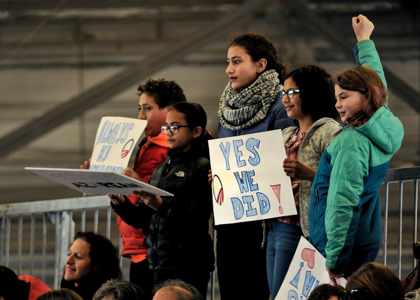 Children hold signs in support of former President Barack Obama during his farewell speech at Joint Base Andrews, Md. Jan. 20, 2017. After his speech Obama and his wife Michelle took time to shake hands and exchange hugs with members of the crowd before boarding a plane to depart. 
