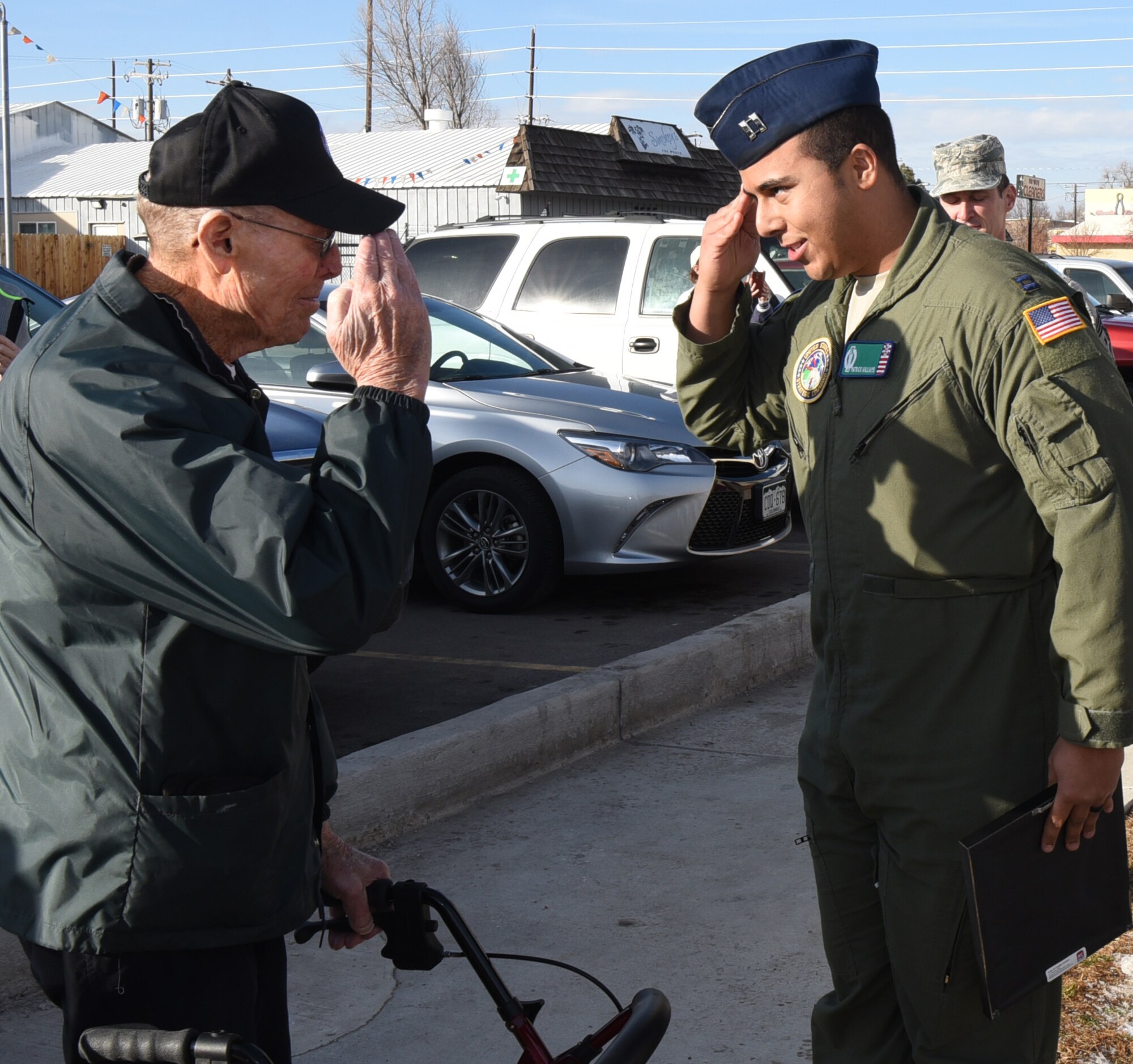 Capt. Patrick Williams, 321st Missile Squadron combat crew commander, renders a salute to Joe Gordy, retired chief master sergeant, at the VFW in Greeley, Colo., Jan. 13, 2017. Williams also presented Gordy with a plaque on behalf of the 90th Missile Wing to thank him for his 28 years of service in the U.S. Air Force. (U.S. Air Force photo by Airman 1st Class Breanna Carter)