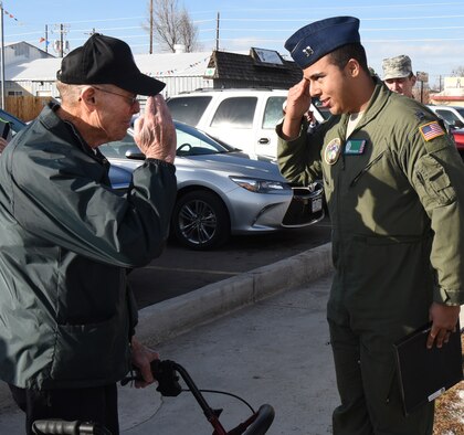 Capt. Patrick Williams, 321st Missile Squadron combat crew commander, renders a salute to Joe Gordy, retired chief master sergeant, at the VFW in Greeley, Colo., Jan. 13, 2017. Williams also presented Gordy with a plaque on behalf of the 90th Missile Wing to thank him for his 28 years of service in the U.S. Air Force. (U.S. Air Force photo by Airman 1st Class Breanna Carter)