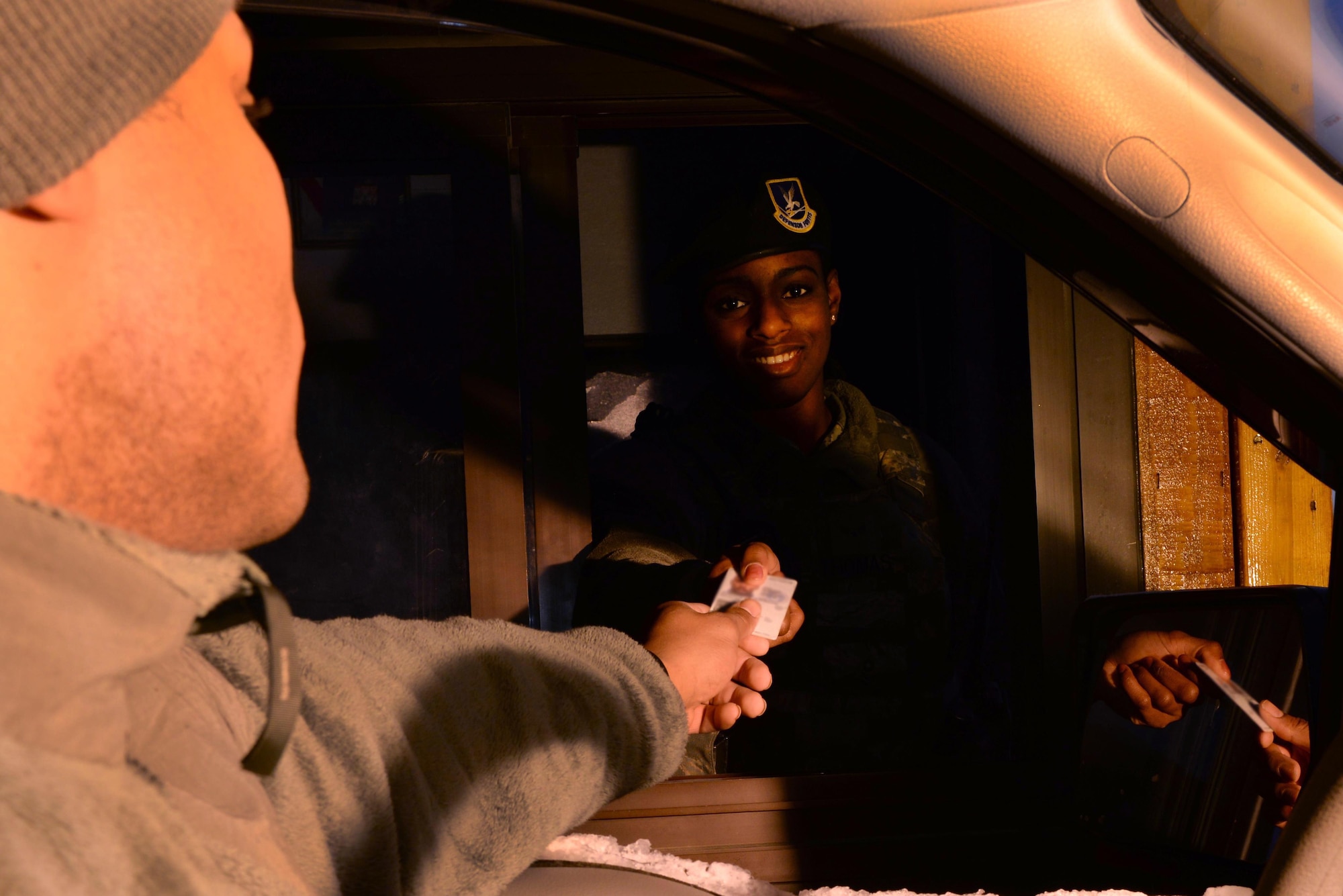 U.S. Air Force Airman Isaac Johnson, a 354th Fighter Wing photojournalist, passes his Common Access Card to Airman 1st Class Kritydra Thomas, a 354th Security Forces Squadron entry controller, on Jan. 20, 2017, at Hursey Gate on Eielson Air Force Base, Alaska. Beginning June 6, 2017, the Alaska state driver's license will be denied entry to federal installations without escort as mandated by the REAL ID Act of 2005. (U.S. Air Force photo by Airman Eric M. Fisher)