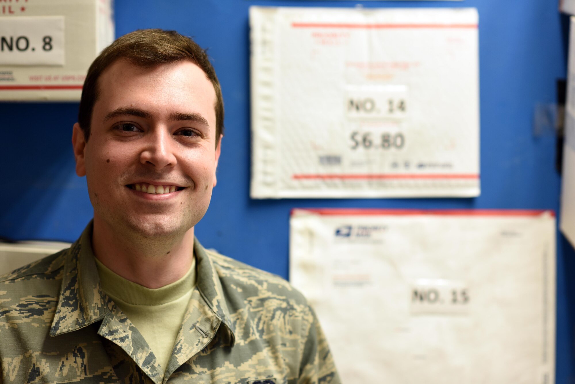 U.S. Air Force Senior Airman Jacob Franklin, a postal clerk with the 379th Expeditionary Communications Squadron post office, poses for a photo Al Udeid Air Base, Qatar, Jan. 19, 2016. The Al Udeid AB post office military control activity section works 365 days a year processing incoming and outgoing packages. (U.S. Air Force photo by Senior Airman Cynthia A. Innocenti)