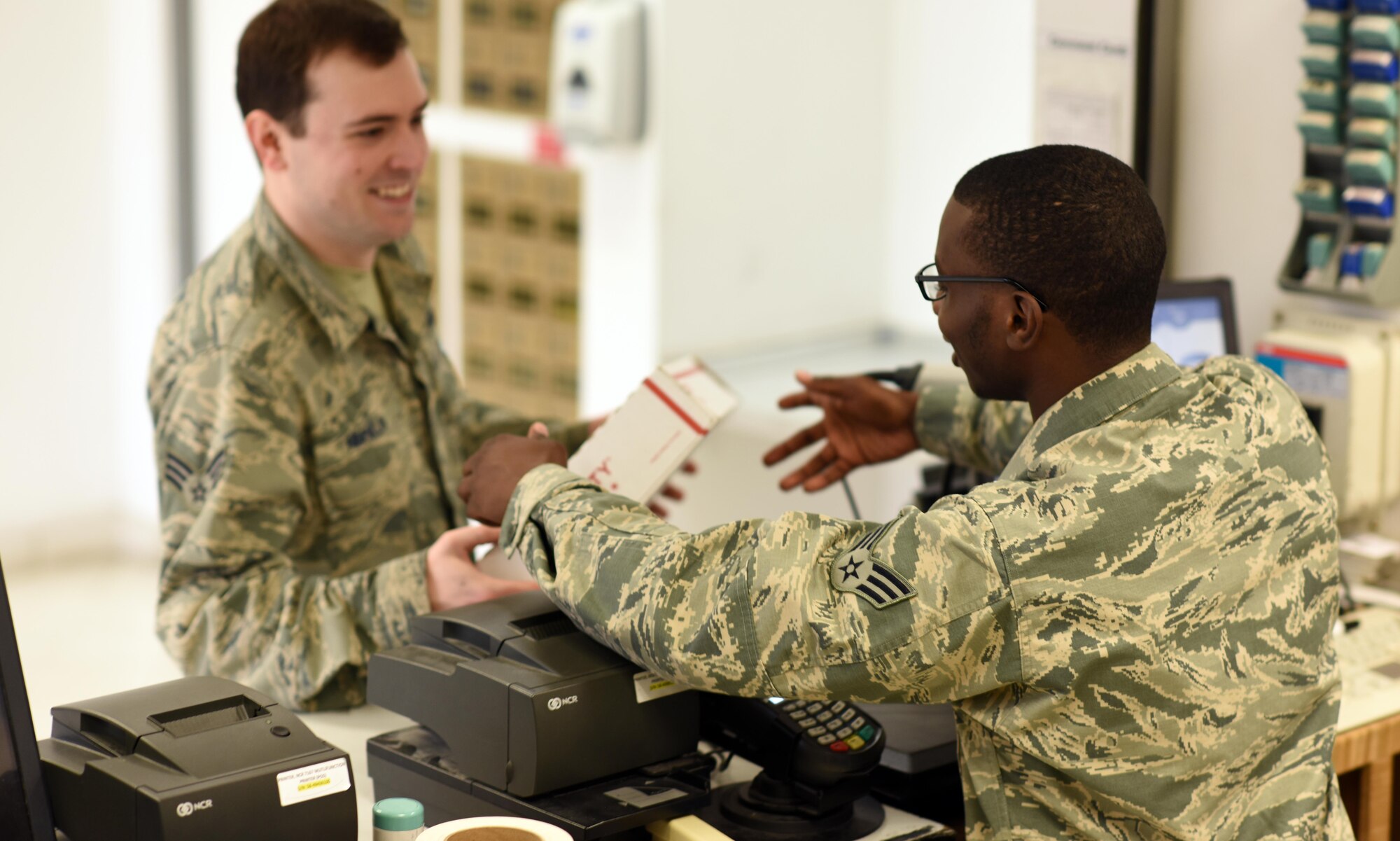 U.S. Air Force Senior Airman Jamal Jenkins, a postal clerk with the 379th Expeditionary Communications Squadron post office, processes a package at Al Udeid Air Base, Qatar, Jan. 19, 2016. These Airmen work day and night to process incoming and outgoing mail. (U.S. Air Force photo by Senior Airman Cynthia A. Innocenti)