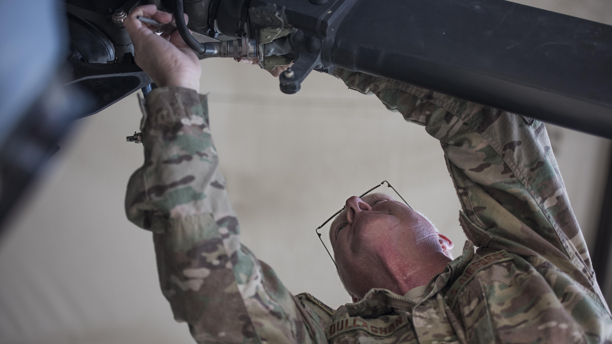 Master Sgt. James Dullaghan, 455th Expeditionary Aircraft Maintenance Squadron Helicopter Maintenance Unit HH-60 Pave Hawk dedicated crew chief, works on the tail rotors of an HH-60 during a 50-hour inspection Jan. 19, 2017 at Bagram Airfield Afghanistan. This is Dullaghan’s first deployment since reenlisting in the Air Force after a twenty-year break in service. (U.S. Air Force photo by Staff Sgt. Katherine Spessa)