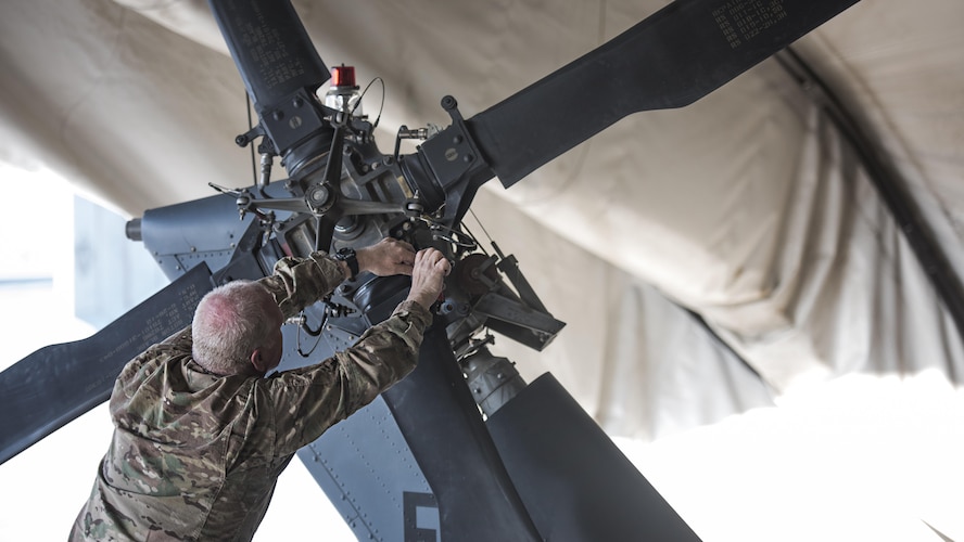 Master Sgt. James Dullaghan, 455th Expeditionary Aircraft Maintenance Squadron Helicopter Maintenance Unit HH-60 Pave Hawk dedicated crew chief, feeds a borescope into an HH-60 during a 50-hour inspection Jan. 19, 2017 at Bagram Airfield Afghanistan. Dullaghan is fulfilling a life-long dream of working on aircraft during his second career in the Air Force. (U.S. Air Force photo by Staff Sgt. Katherine Spessa)