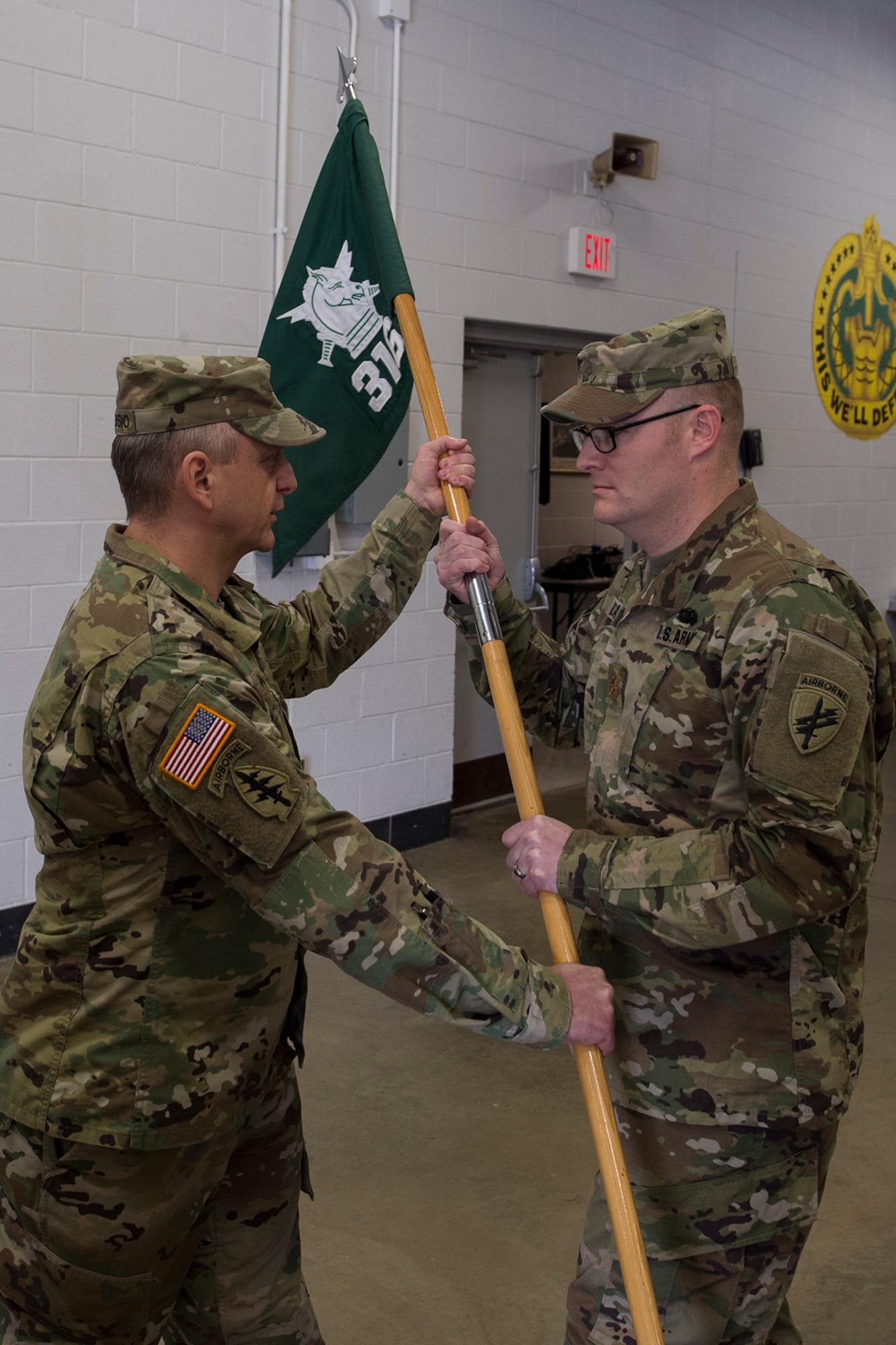 Lt. Col. Christopher Ambrosio, 16th Psychological Operations Battalion commander passes the guidon, and by extension command of the 316th Psychological Operations Company, to Maj. Glenn Laws, 316th PSYOP Co. commander, during a change of command ceremony January 21, 2017 at Grissom Air Reserve Base, Ind. Laws has been with the 316th PSYOP Co. since 2001. (U.S. Air Force photo/Staff Sgt. Dakota Bergl)
