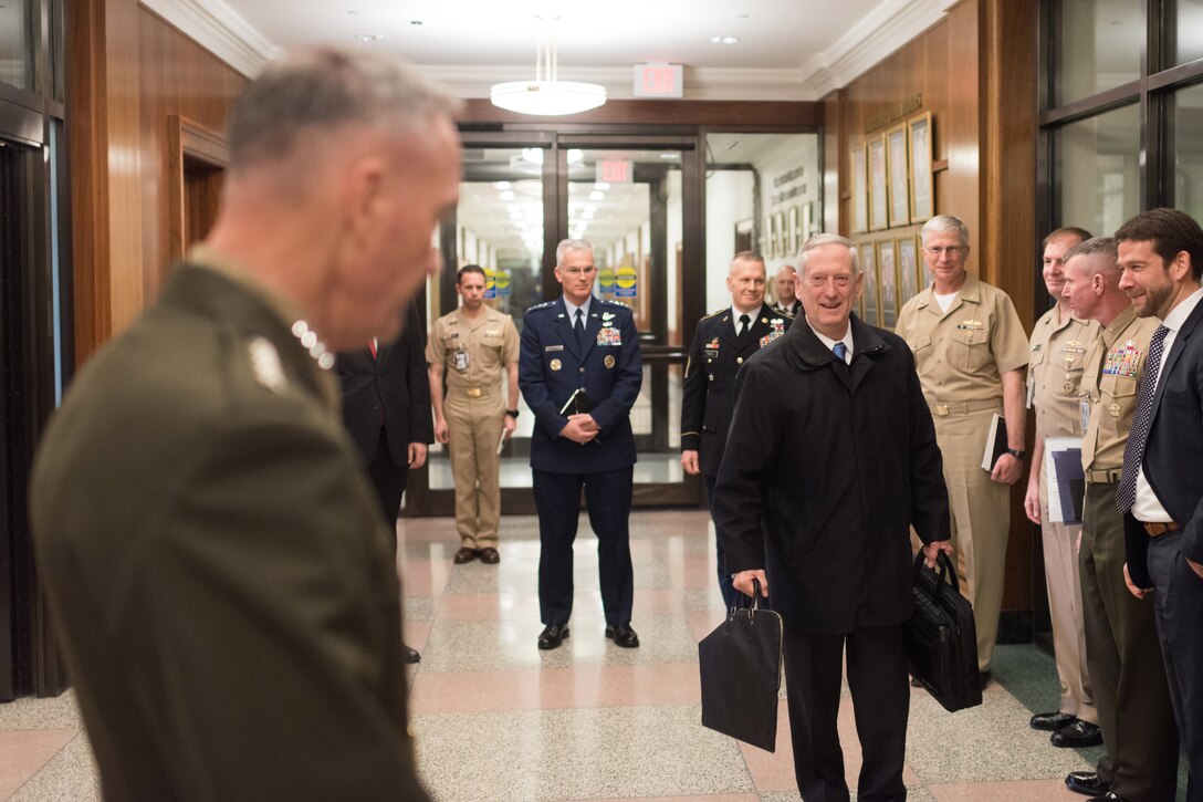 Defense Secretary Jim Mattis greets Marine Corps Gen. Joe Dunford, left, chairman of the Joint Chiefs of Staff, during his first day at the Pentagon as secretary, Jan. 21, 2017. DoD photo by D. Myles Cullen