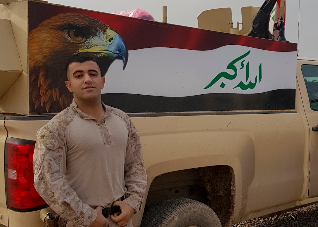 Cpl. Ali J. Mohammed, a Baghdad, Iraq native and a supply Marine with 3rd Battalion, 7th Marine Regiment, stands in front of the painting an Iraqi flag while in Northern Iraq, Dec. 26, 2016. Mohammed, fluent in Arabic, has strengthened the partnership between SPMAGTF Marines and Iraqi military members by translating pertinent information to support their operations. SPMAGTF Marines enable Combined Joint Task Force-Operation Inherent Resolve with security forces, strikes, and advise and assist teams, all of which support the Iraqis in their efforts to defeat ISIL.