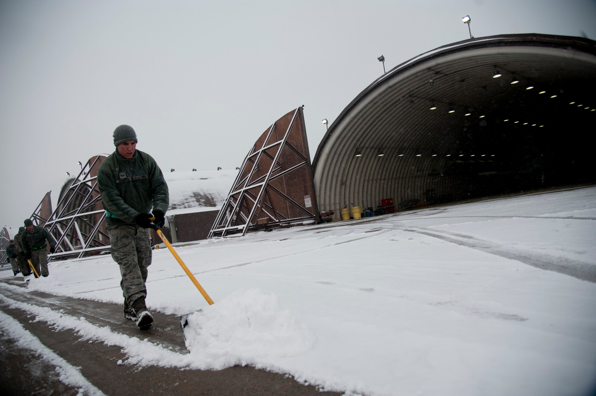 U.S. Air Force Senior Airman Joshua Johnston, 25th Aircraft Maintenance Unit avionics system technician, shovels snow in front of an aircraft hangar on Osan Air Base, Republic of Korea, Jan. 20, 2017. The 25th AMU removed snow in front of their hangers to keep the A-10 Thunderbolt II “ready to fight tonight”. (U.S. Air Force photo by Staff Sgt. Jonathan Steffen)