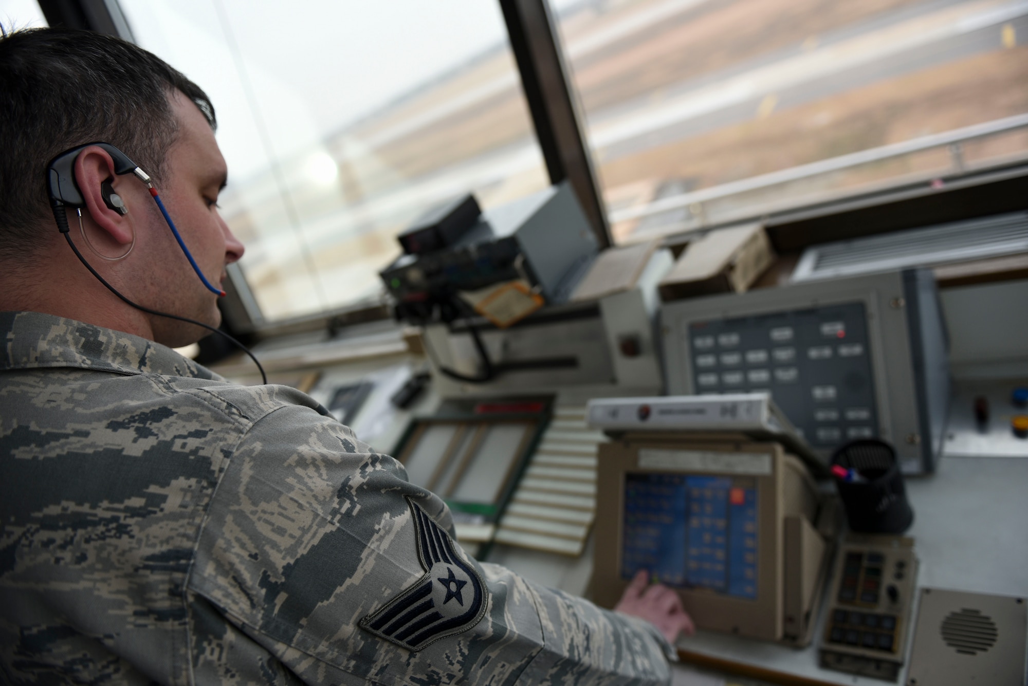 Staff Sgt. Jeffery Howard, 8th Operations Support Squadron air traffic controller, adjusts his radio frequency at Kunsan Air Base, Republic of Korea, Jan. 5, 2017. Howard’s primary responsibilities include communicating with aircraft entering and leaving Kunsan airspace. (U.S. Air Force photo by Senior Airman Michael Hunsaker/Released)