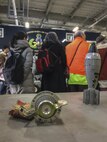 Various examples of improvised and conventional explosive devices litter a table be-hind a group of Japanese nationals who toured the 35th Civil Engineer Squadron’s ex-plosive ordnance disposal flight at Misawa Air Base, Japan, Jan. 20, 2017. The group were part of a monthly community engagement tour that builds trust and support with Misawa AB’s host partners by highlighting various units around the base and includes a windshield tour along the installation’s perimeter road. (U.S. Air Force photo by Staff Sgt. Benjamin W. Stratton)