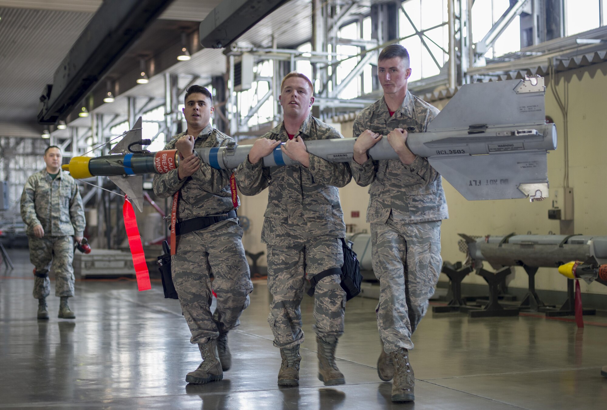 U.S. Air Force Airmen with the 13th Aircraft Maintenance Unit load crew 3, carry an AIM-9 Sidewinder short-range air-to-air missile during the annual load crew competition at Misawa Air Base, Japan, Jan. 20, 2017. The AIM-9 Sidewinder, is effective in both air-to-air and surface-to-air applications. (U.S. Air Force photo by Senior Airman Brittany A. Chase)