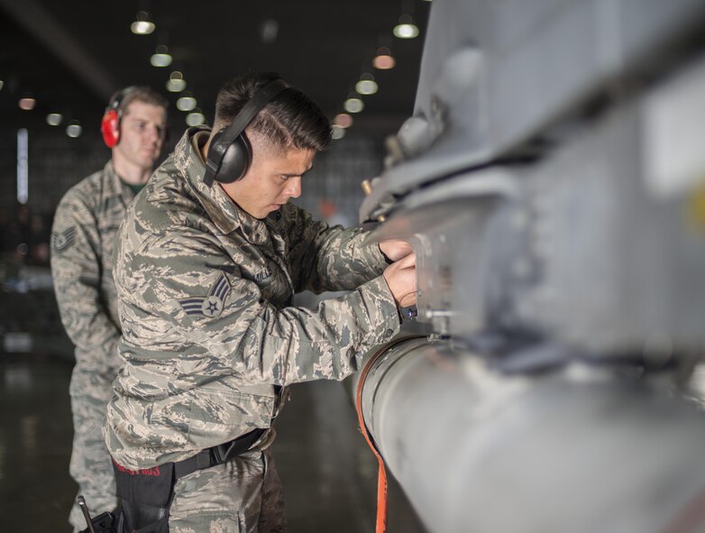 U.S. Air Force Senior Airman Daniel Miller, the 2-man with the 13th Aircraft Maintenance Unit load crew 3, checks a panel during the annual load crew competition at Misawa Air Base, Japan, Jan. 20, 2017. Both quality and speed were judged during the competition by weapons standardization Airmen with the 35th Maintenance Group. (U.S. Air Force photo by Senior Airman Brittany A. Chase)