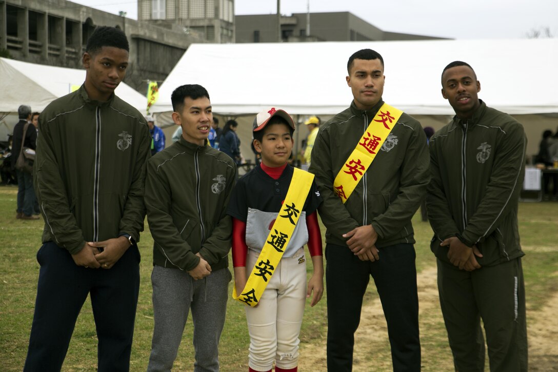 MARINE CORPS AIR STATION FUTENMA, OKINAWA, Japan – Marines pose for a group photo Jan. 21 after the Ginowan City Traffic Safety Relay Race at Marine Corps Air Station Futenma. The 14-kilometer race around the perimeter of MCAS Futenma was an effort by Ginowan City to raise awareness about traffic safety. The Ginowan City fire department took first and second place, with the Marines coming in third.