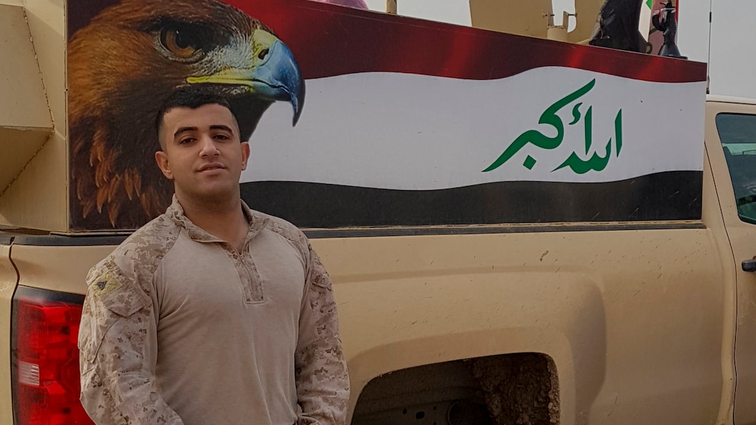 Cpl. Ali J. Mohammed, a Baghdad, Iraq native and a supply Marine with 3rd Battalion, 7th Marine Regiment, Special Purpose Marine Air-Ground Task Force-Crisis Response-Central Command, stands in front of the painting an Iraqi flag while in Northern Iraq, Dec. 26, 2016. Mohammed, fluent in Arabic, has strengthened the partnership between SPMAGTF Marines and Iraqi military members by translating pertinent information to support their operations. SPMAGTF Marines enable Combined Joint Task Force-Operation Inherent Resolve with security forces, strikes, and advise and assist teams, all of which support the Iraqis in their efforts to defeat ISIL.