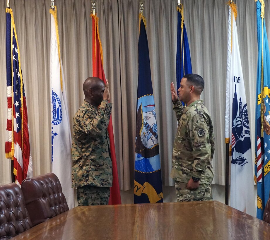 DLA Distribution San Joaquin commander Marine Col. Dre Harrell administers the Oath of Office to Army Master Sgt. Scotty Mackay during his Jan. 4 promotion ceremony.