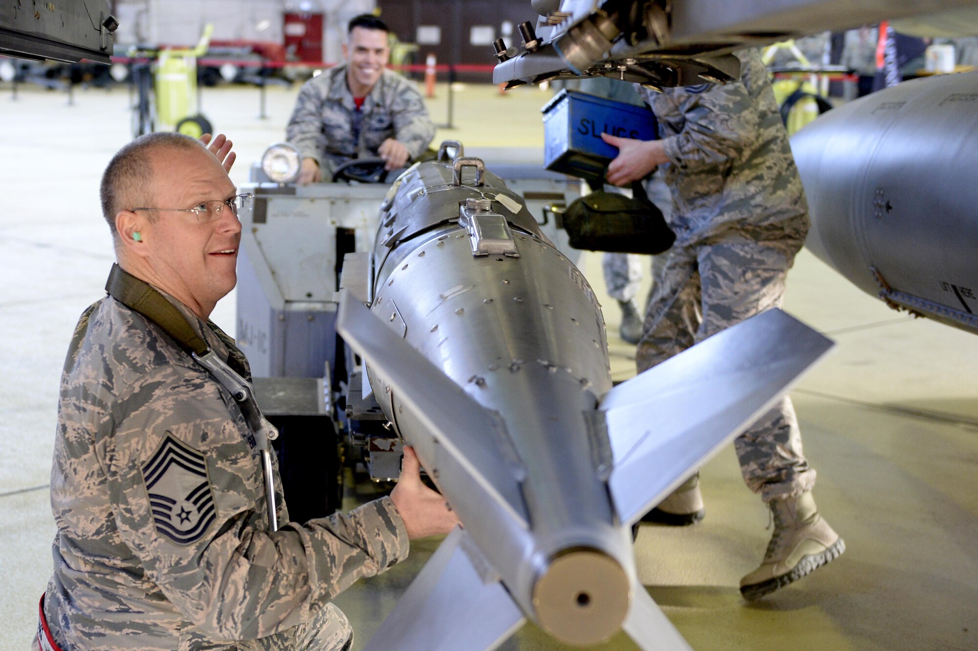 Chief Master Sgt. Craig Brandenburg, 52nd Maintenance Group wing weapons manager, loads an inert bomb on an F-16 Fighting Falcon during the chief load crew competition in Hanger One at Spangdahlem Air Base, Germany, Jan. 20, 2017. The competition pitted a group of three senior leaders against an active load crew as part of the lead-up to the Annual Load Crew Competition. (U.S. Air Force photo by Staff Sgt. Staci Miller)