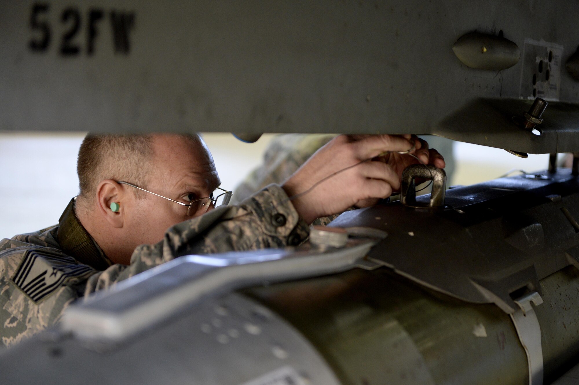 Chief Master Sgt. Craig Brandenburg, 52nd Maintenance Group wing weapons manager, loads an inert bomb on an F-16 Fighting Falcon during the chief load crew competition in Hanger One at Spangdahlem Air Base, Germany, Jan. 20, 2017. The competition pitted a group of three senior leaders against an active load crew as part of the lead-up to the Annual Load Crew Competition. (U.S. Air Force photo by Staff Sgt. Staci Miller)